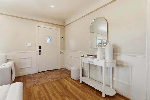 a view of a kitchen with furniture and wooden floor