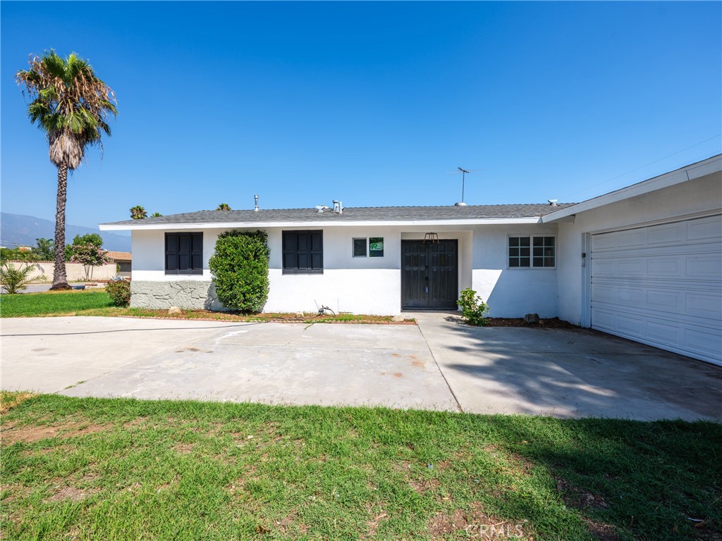 8419 18th Street Rancho Cucamonga, CA 91701 - Photo 1 of 28 a front view of a house with a yard and garage