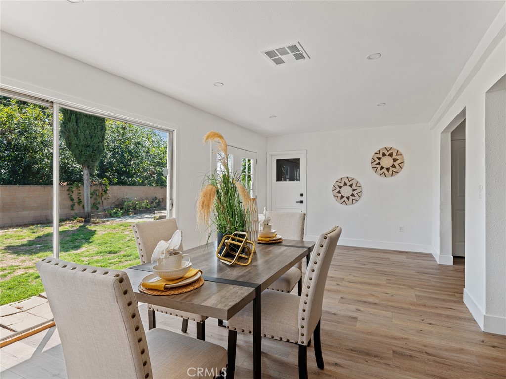 8419 18th Street Rancho Cucamonga, CA 91701 - Photo 13 of 28 a view of a dining room with furniture window and wooden floor