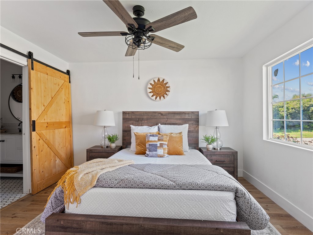 8419 18th Street Rancho Cucamonga, CA 91701 - Photo 18 of 28 a bedroom with a large bed and a chandelier