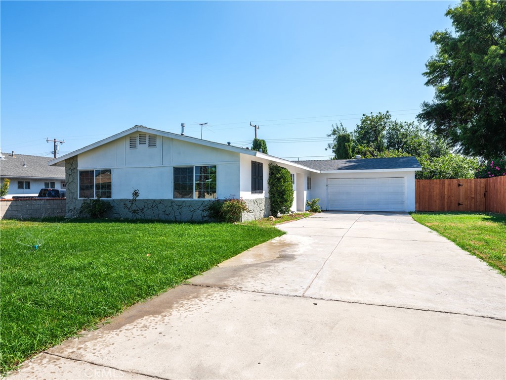 8419 18th Street Rancho Cucamonga, CA 91701 - Photo 2 of 28 a front view of house with yard and car parked