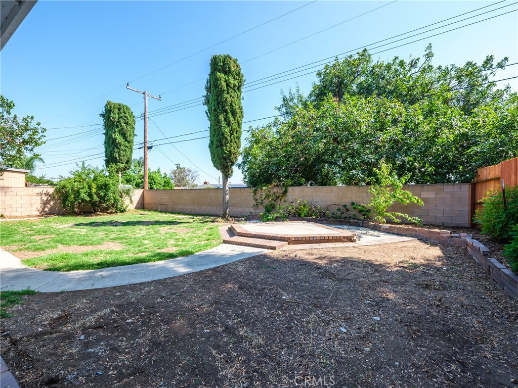 8419 18th Street Rancho Cucamonga, CA 91701 - Photo 25 of 28 a front view of a house with a yard and garage