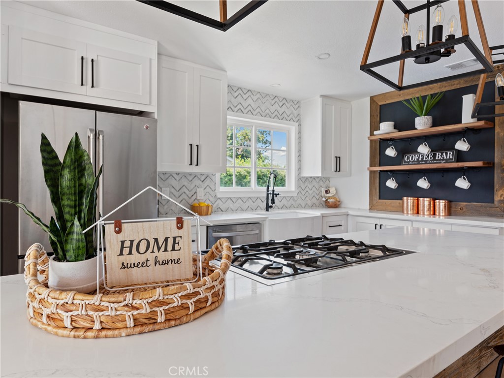 8419 18th Street Rancho Cucamonga, CA 91701 - Photo 4 of 28 a kitchen with a stove a window and cabinets
