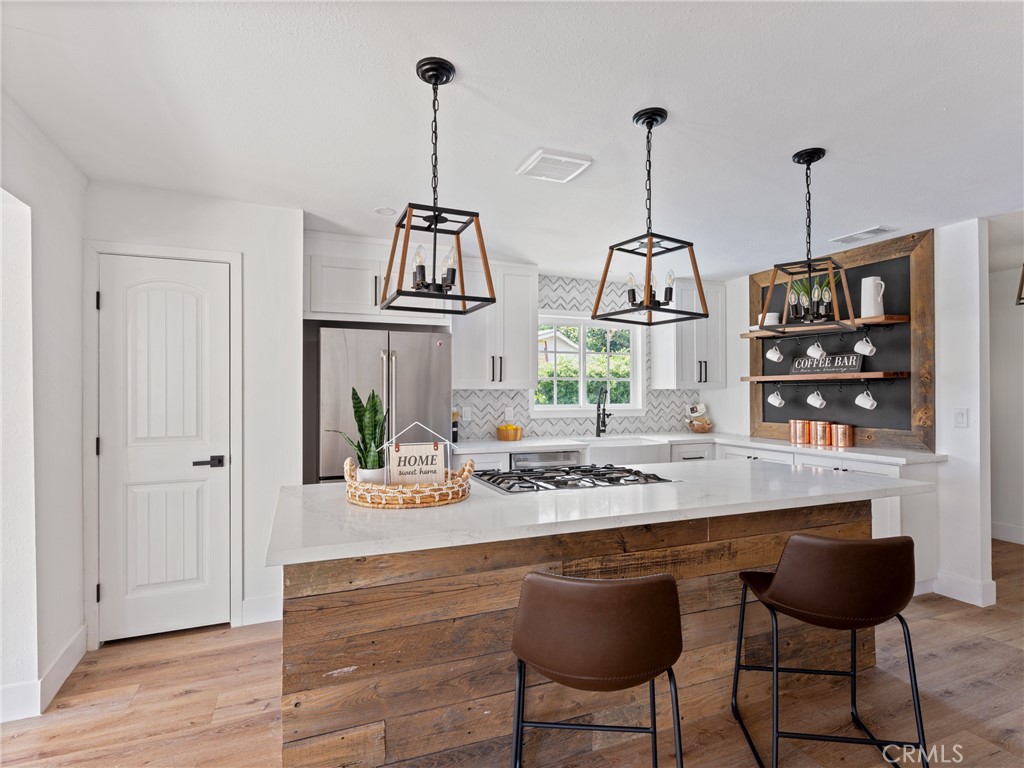 8419 18th Street Rancho Cucamonga, CA 91701 - Photo 5 of 28 a view of a dining room with furniture wooden floor and chandelier
