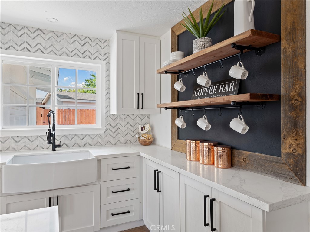 8419 18th Street Rancho Cucamonga, CA 91701 - Photo 6 of 28 a bathroom with a sink a vanity and a mirror