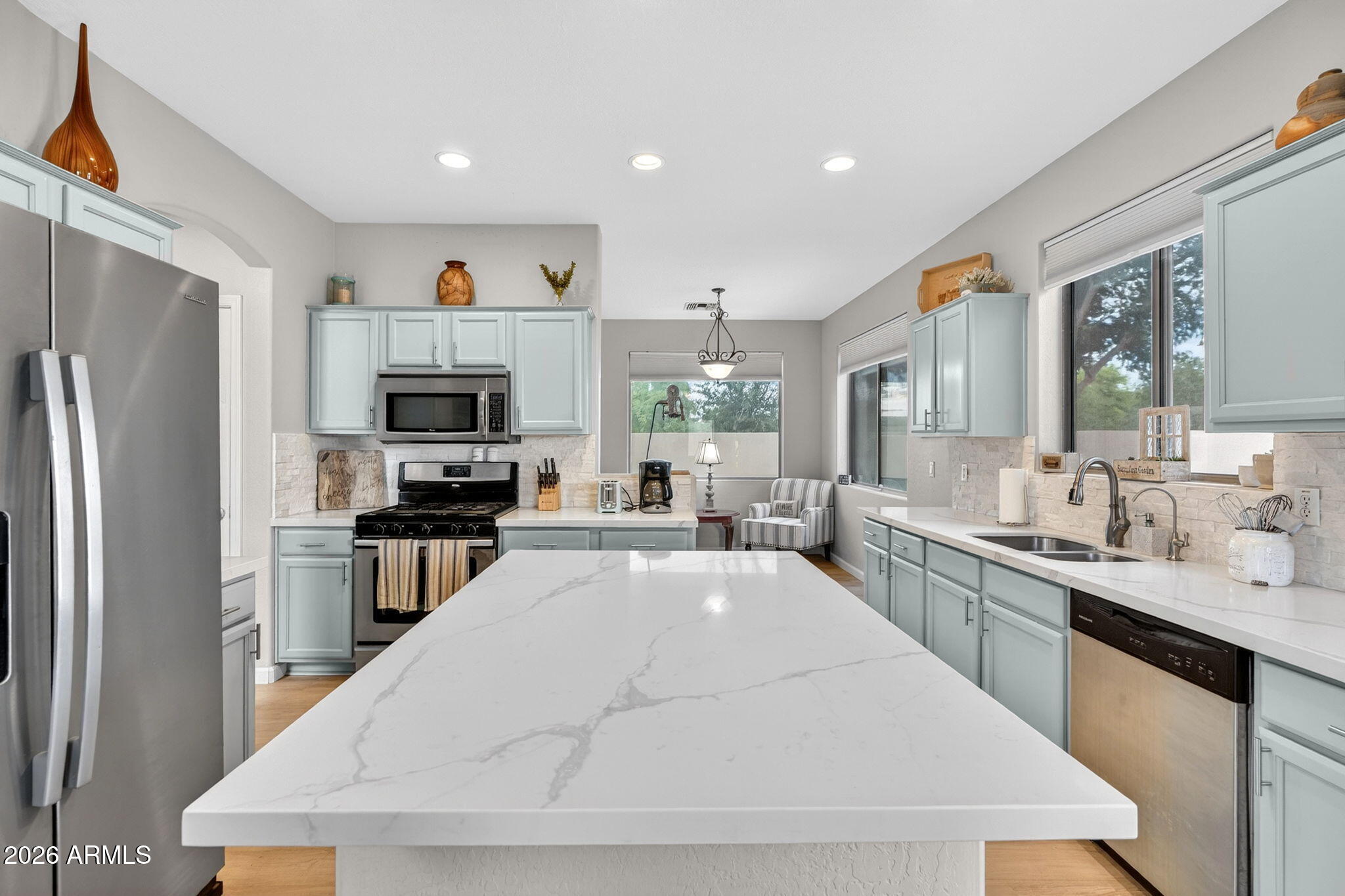 6280 South Sinova Court Gilbert, AZ 85298 - Photo 17 of 64 a large white kitchen with stainless steel appliances