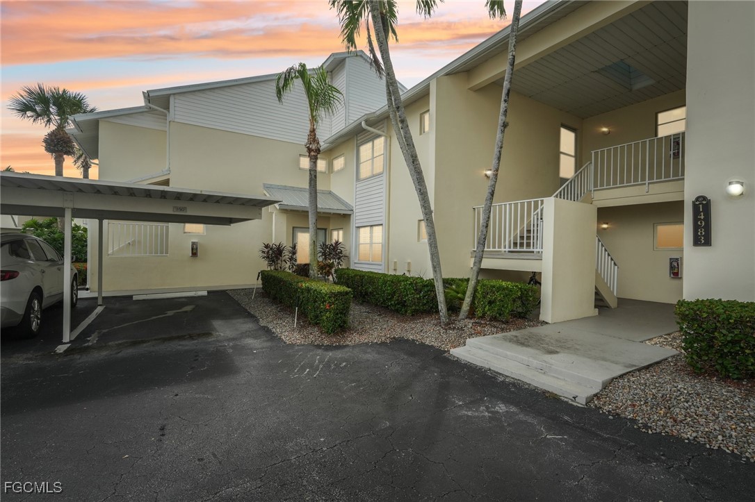 14983 Rivers Edge Court, Unit 230 Fort Myers, FL 33908 - Photo 1 of 47 a view of a street with a building in the background