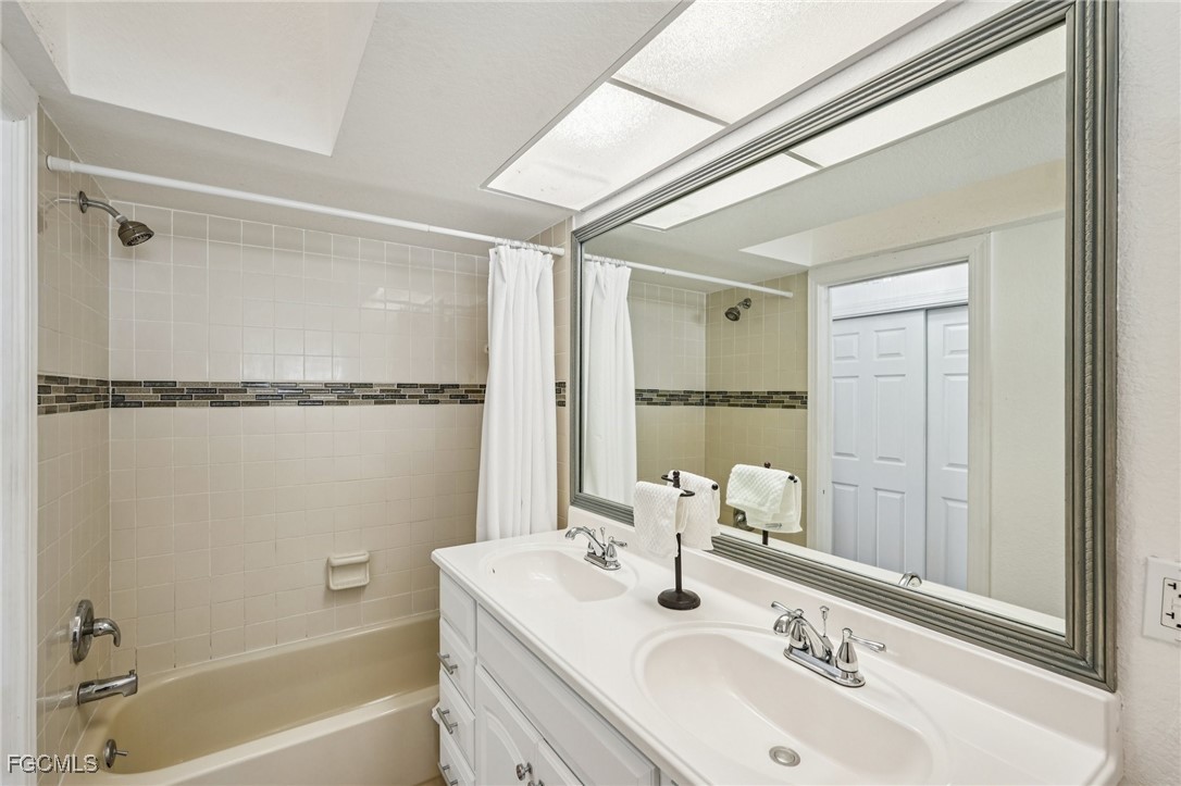 14983 Rivers Edge Court, Unit 230 Fort Myers, FL 33908 - Photo 19 of 47 a bathroom with a sink and a mirror