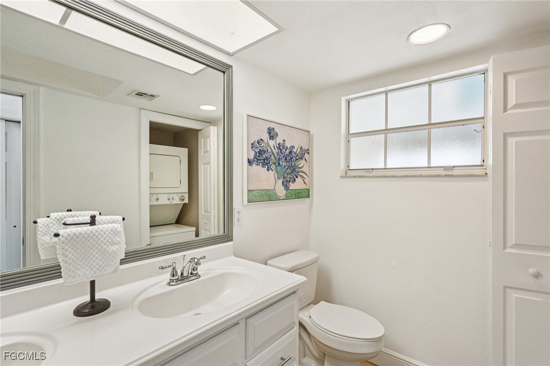 14983 Rivers Edge Court, Unit 230 Fort Myers, FL 33908 - Photo 20 of 47 a bathroom with a sink a toilet and mirror