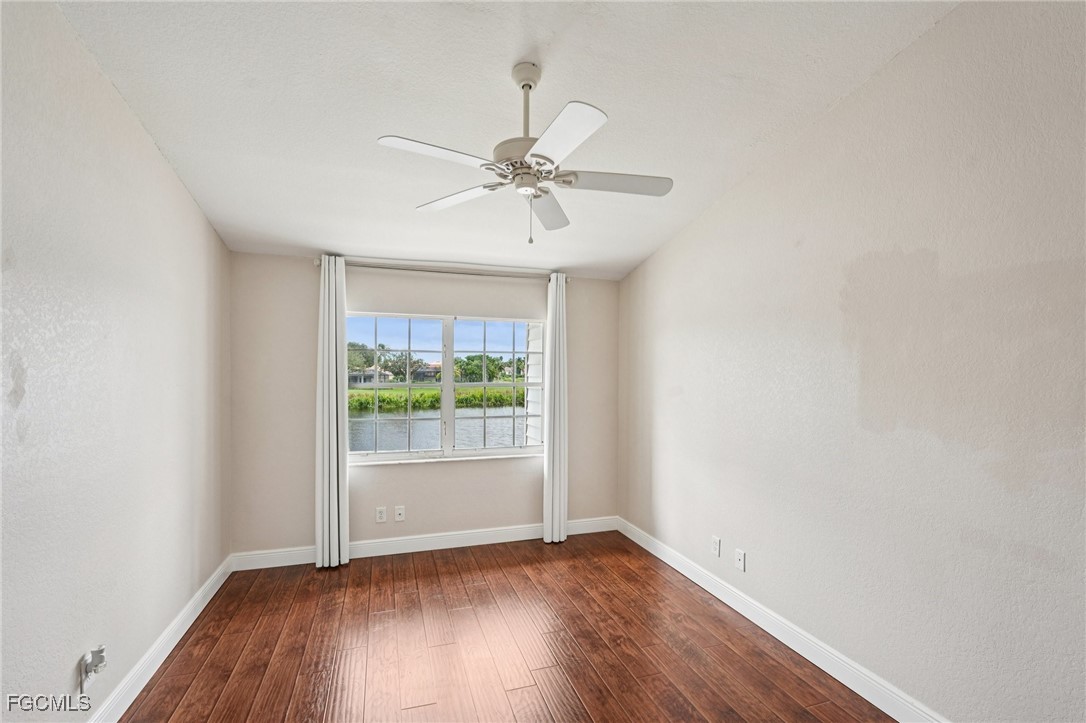 14983 Rivers Edge Court, Unit 230 Fort Myers, FL 33908 - Photo 22 of 47 an empty room with wooden floor and windows