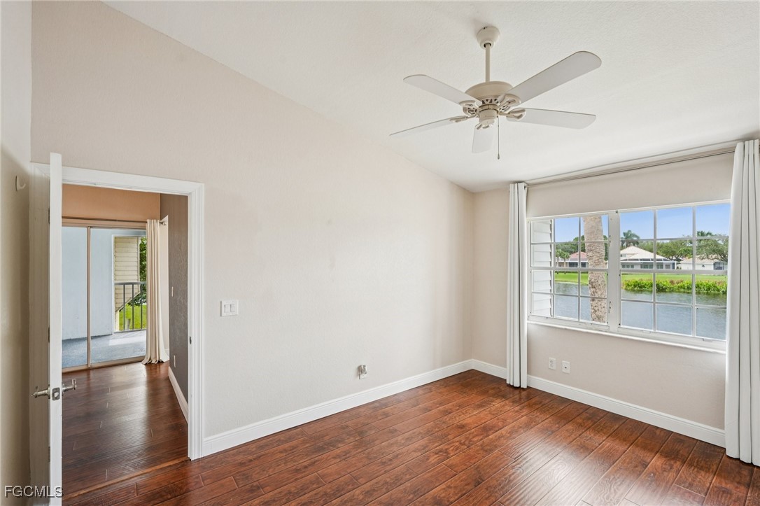 14983 Rivers Edge Court, Unit 230 Fort Myers, FL 33908 - Photo 23 of 47 an empty room with wooden floor fan and windows