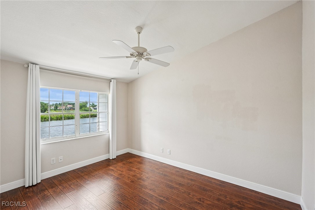14983 Rivers Edge Court, Unit 230 Fort Myers, FL 33908 - Photo 24 of 47 a view of an empty room with wooden floor and a window