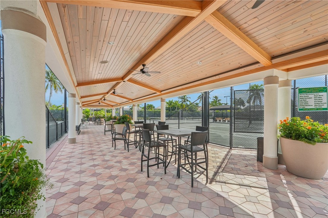 14983 Rivers Edge Court, Unit 230 Fort Myers, FL 33908 - Photo 39 of 47 a view of a patio with a table chairs and a backyard