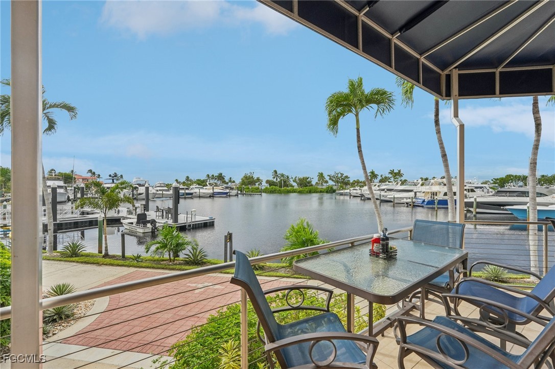 14983 Rivers Edge Court, Unit 230 Fort Myers, FL 33908 - Photo 43 of 47 a view of a lake with a table and chairs
