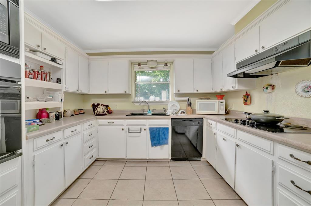 6021 Sycamore Creek Road Edgecliff Village, TX 76134 - Photo 14 of 37 Kitchen with black appliances, under cabinet range hood, a sink, white cabinets, and light tile patterned flooring