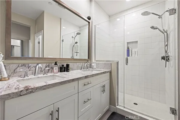 a bathroom with a granite countertop sink mirror and double