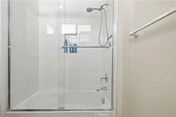 a bathroom with a glass shower door