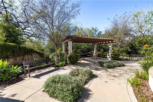 a view of a backyard with sitting area and garden