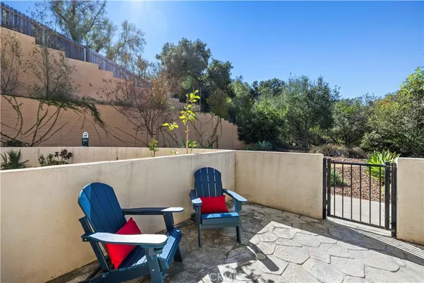 a view of outdoor sitting area with furniture and wooden fence