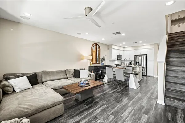 a living room with lots of furniture and kitchen view