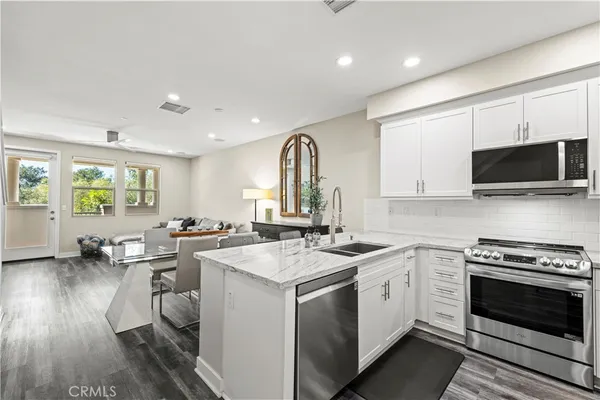 a kitchen with a stove a sink and a microwave