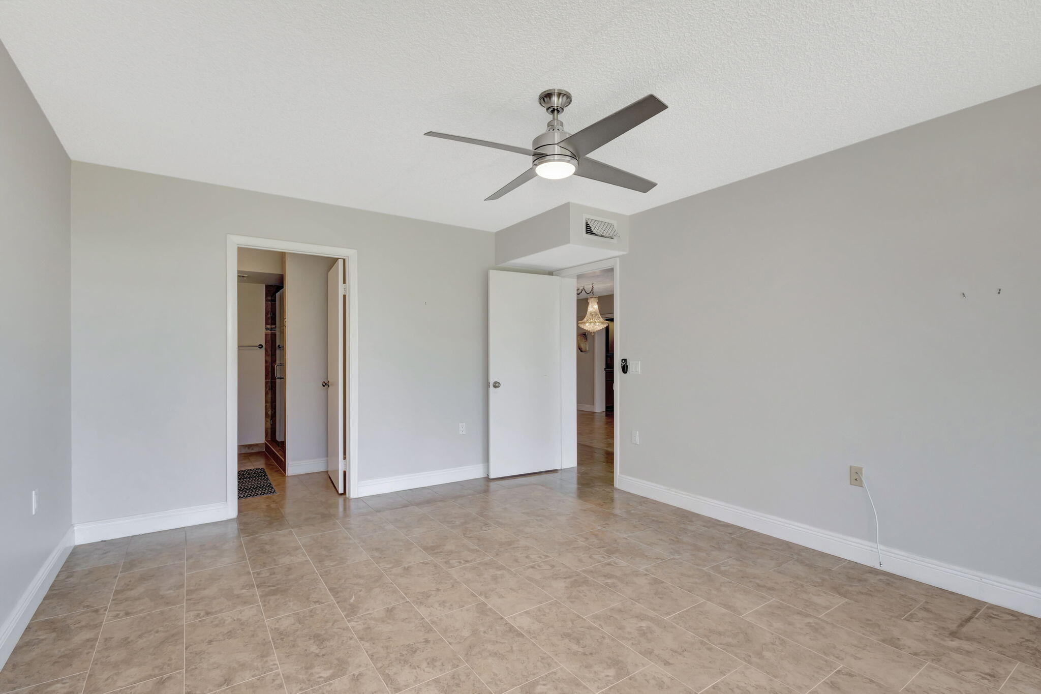 2741 Village Boulevard, Unit 104 West Palm Beach, FL 33409 - Photo 12 of 37 an empty room with closet and a ceiling fan