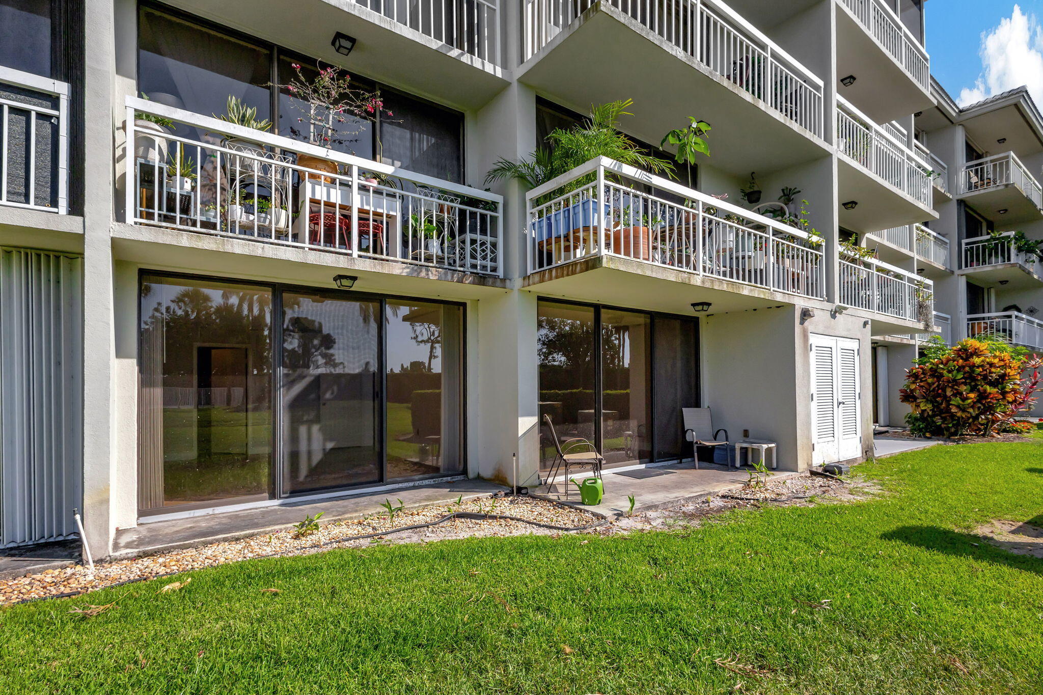 2741 Village Boulevard, Unit 104 West Palm Beach, FL 33409 - Photo 13 of 37 front view of a building with a yard