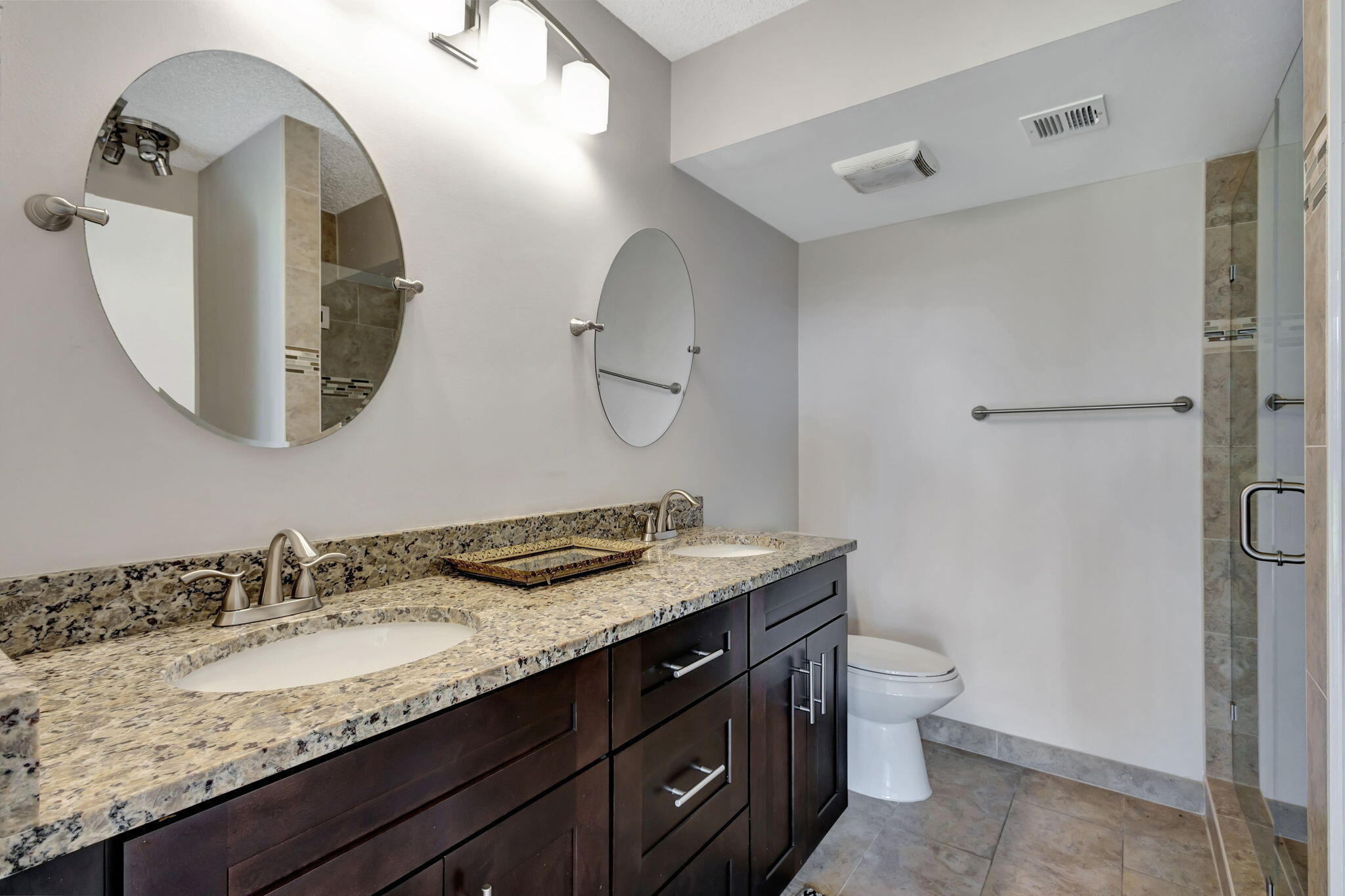 2741 Village Boulevard, Unit 104 West Palm Beach, FL 33409 - Photo 14 of 37 a bathroom with a granite countertop sink and a mirror