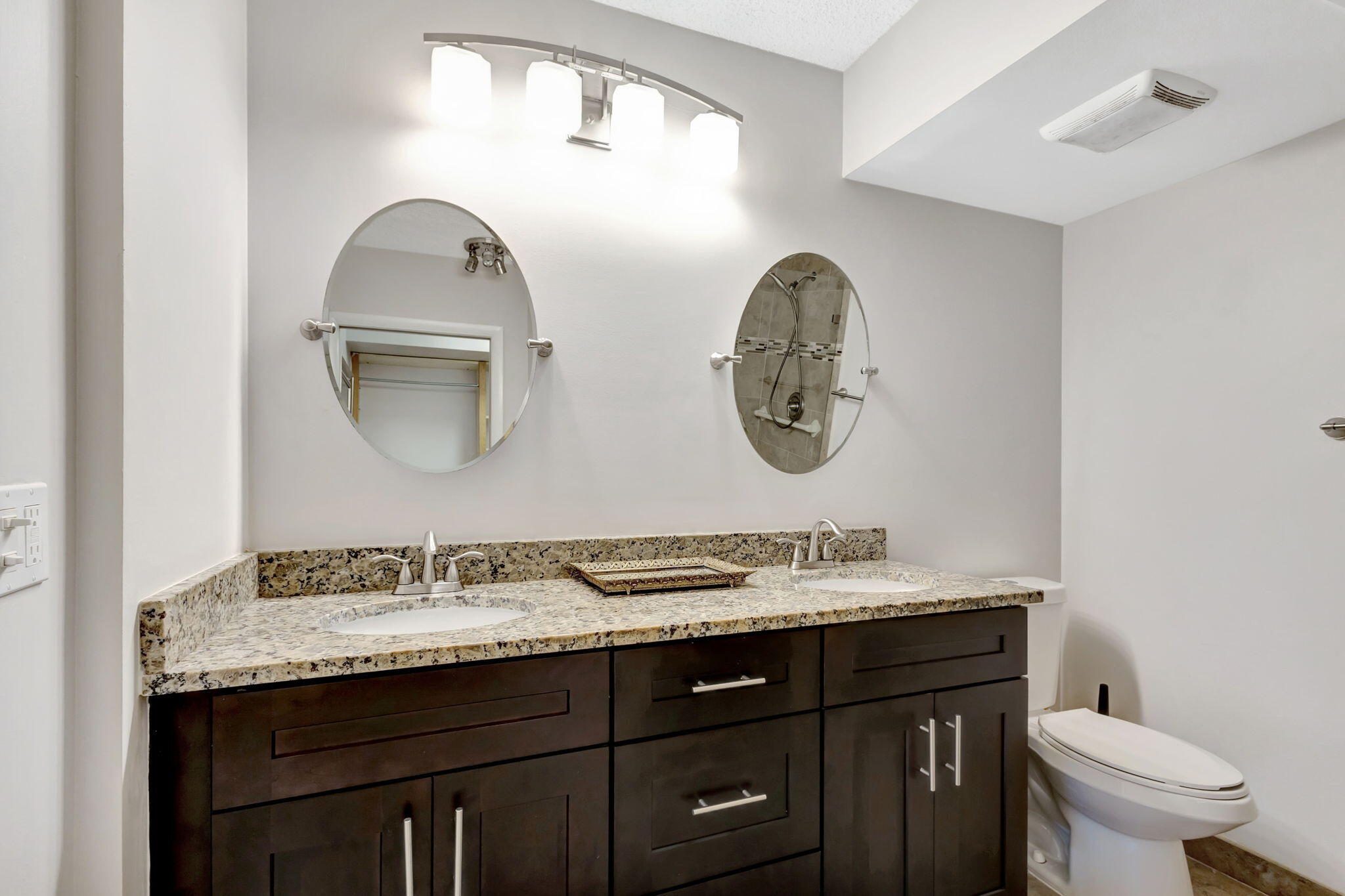 2741 Village Boulevard, Unit 104 West Palm Beach, FL 33409 - Photo 15 of 37 a bathroom with a granite countertop sink and a mirror