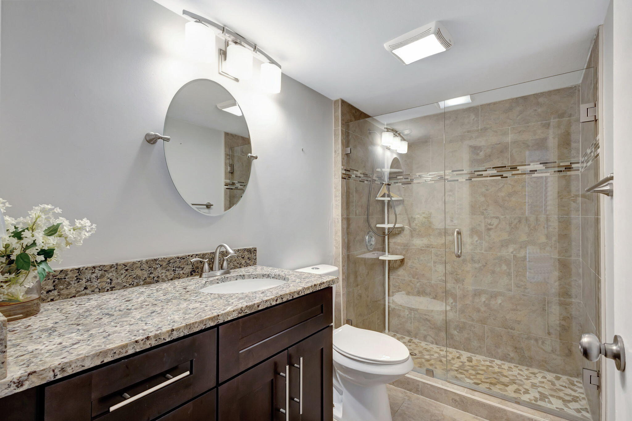 2741 Village Boulevard, Unit 104 West Palm Beach, FL 33409 - Photo 21 of 37 a bathroom with a granite countertop sink a toilet and shower