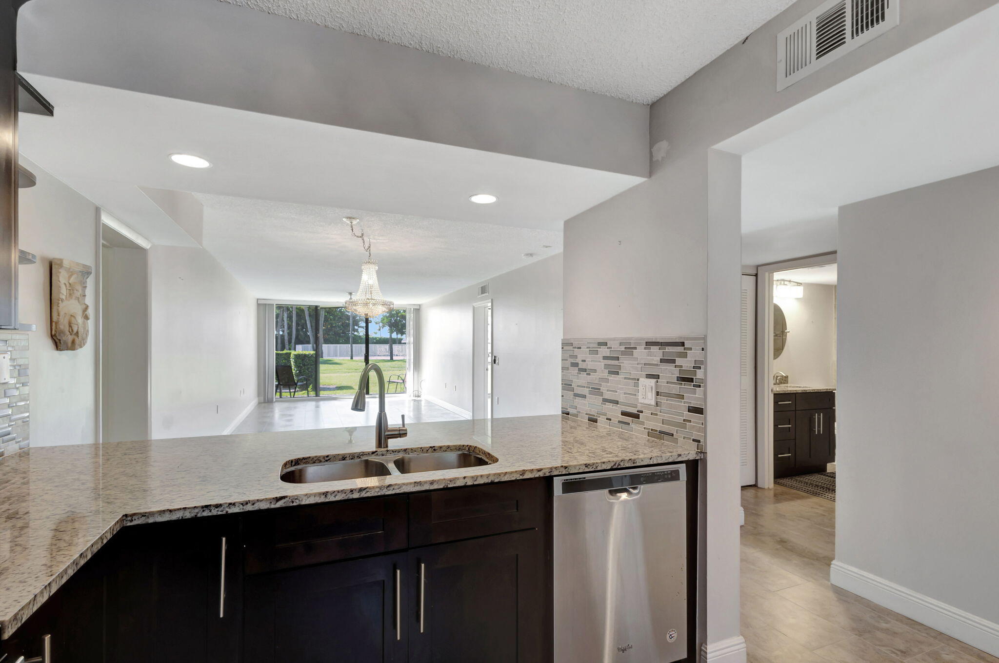 2741 Village Boulevard, Unit 104 West Palm Beach, FL 33409 - Photo 4 of 37 a kitchen with stainless steel appliances a sink and a refrigerator