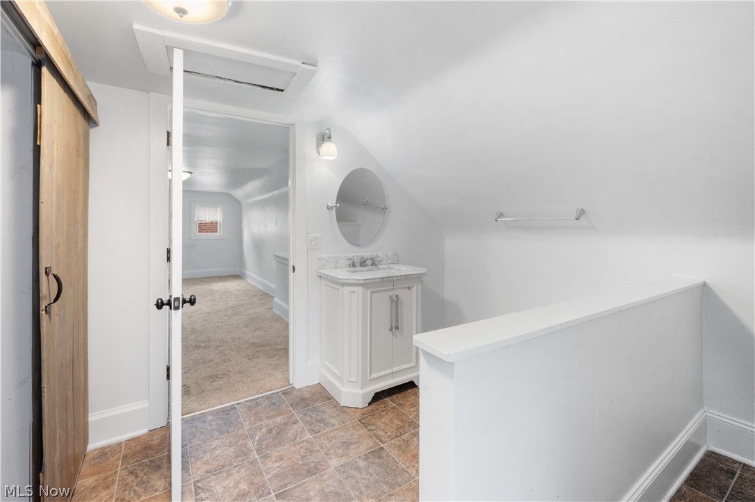 371 Merriman Road Akron, OH 44303 - Photo 26 of 27 Attic bathroom featuring a white vanity with a stone countertop and an oval mirror