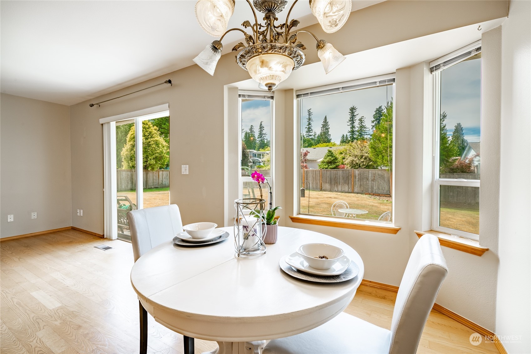 8087 Kispiox Road Blaine, WA 98230 - Photo 16 of 37 a dining room with furniture wooden floor and a chandelier