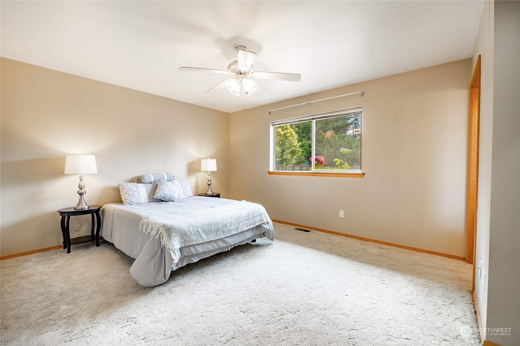 8087 Kispiox Road Blaine, WA 98230 - Photo 21 of 37 a spacious bedroom with a bed and a chandelier