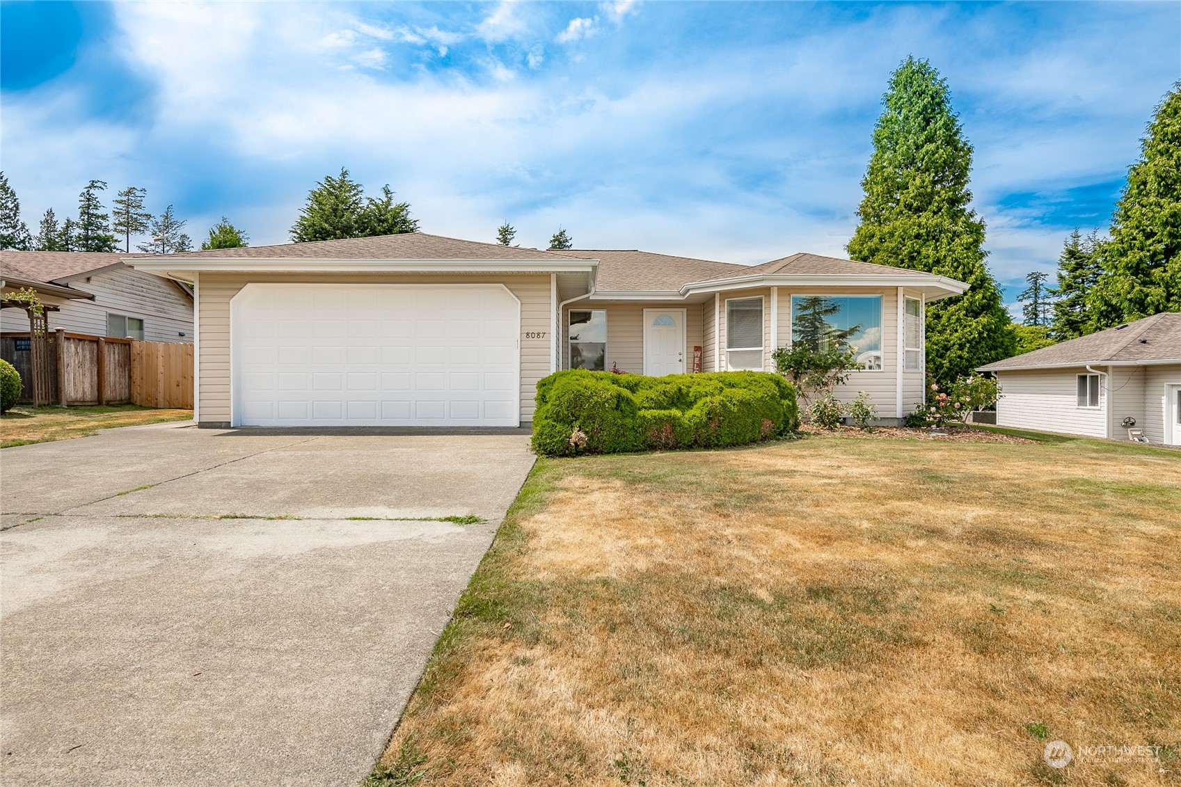 8087 Kispiox Road Blaine, WA 98230 - Photo 3 of 37 a front view of a house with a yard and garage