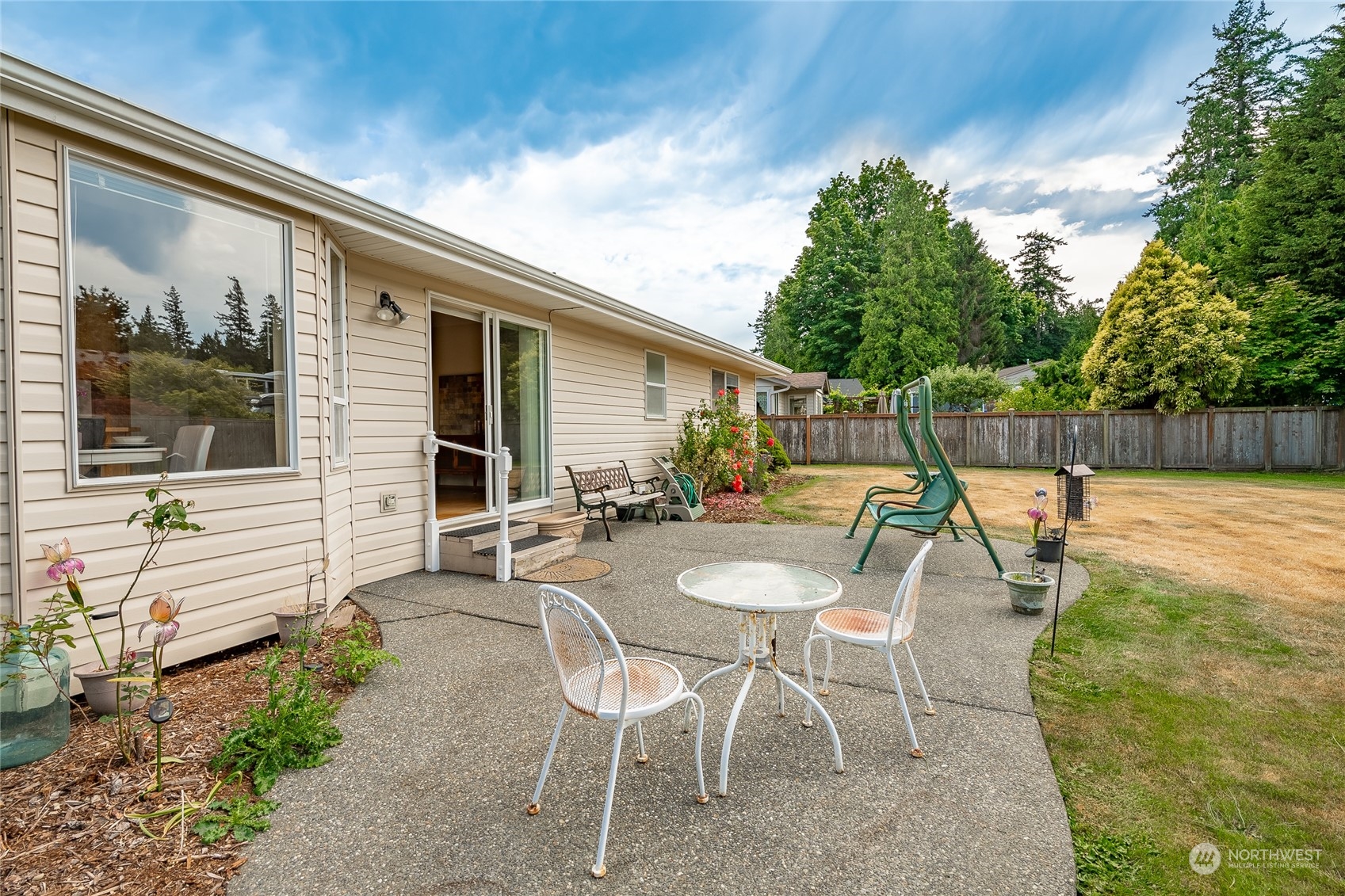 8087 Kispiox Road Blaine, WA 98230 - Photo 34 of 37 a view of a patio with a table chairs and a backyard