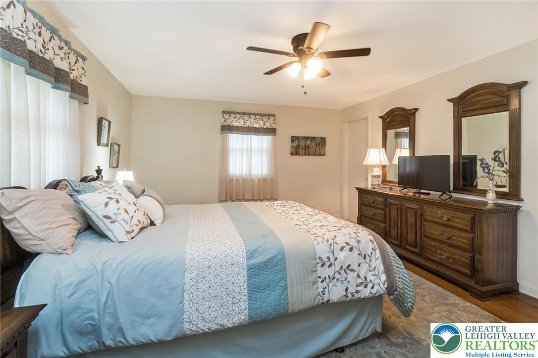 525 Wedgewood Road Bethlehem, PA 18017 - Photo 29 of 61 Relax in this 1st floor primary suite, featuring a beautiful hardwood flooring and a cooling ceiling fan for ultimate comfort.