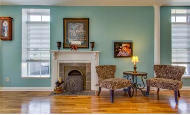 a living room with furniture and a fireplace