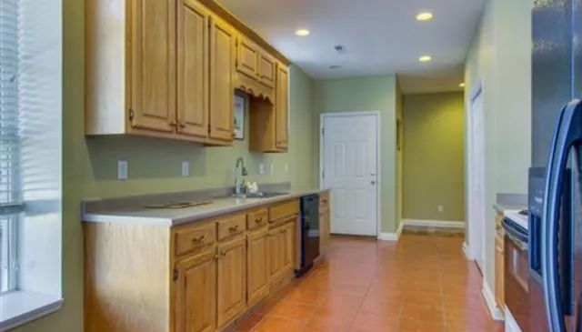 a kitchen with stainless steel appliances granite countertop a sink and cabinets
