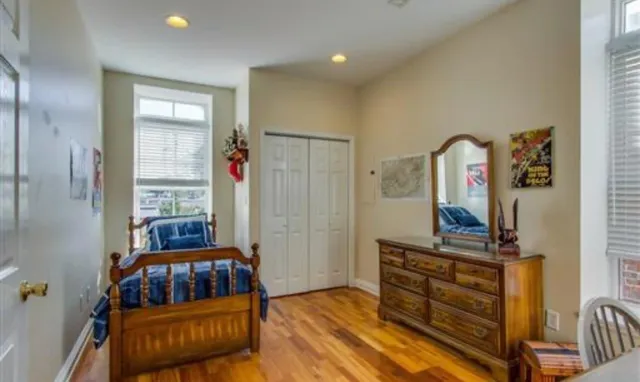 a bedroom with furniture and a window