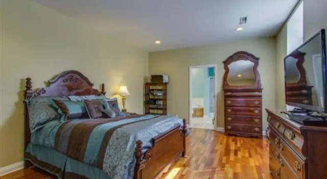 a bedroom with a bed and a television