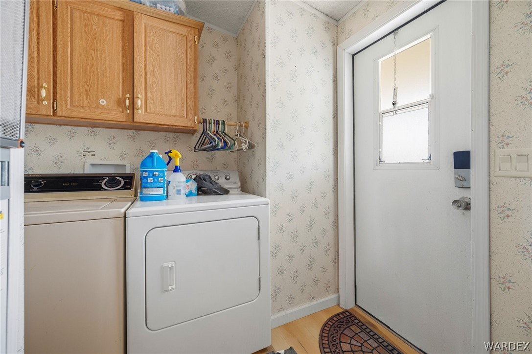 2465 Egar Road Golden Valley, AZ 86413 - Photo 26 of 98 The property features a dedicated area for laundry appliances with overhead cabinetry for storage