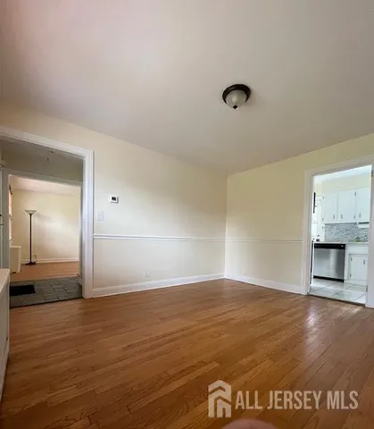 a view of empty room with window and fireplace