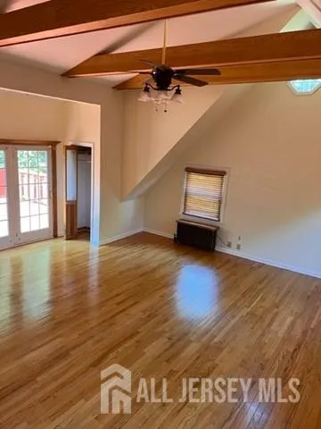 a view of a room with wooden floor