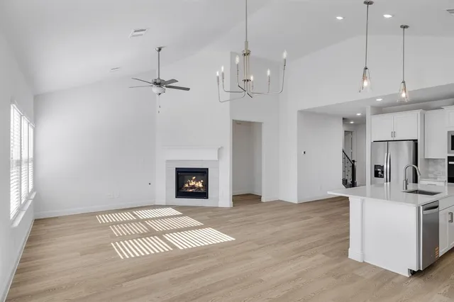 a view of kitchen and hall with wooden floor