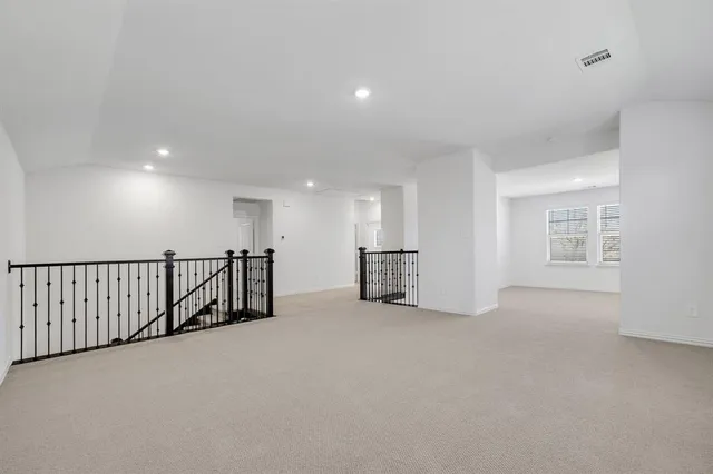 a view of an empty room with windows