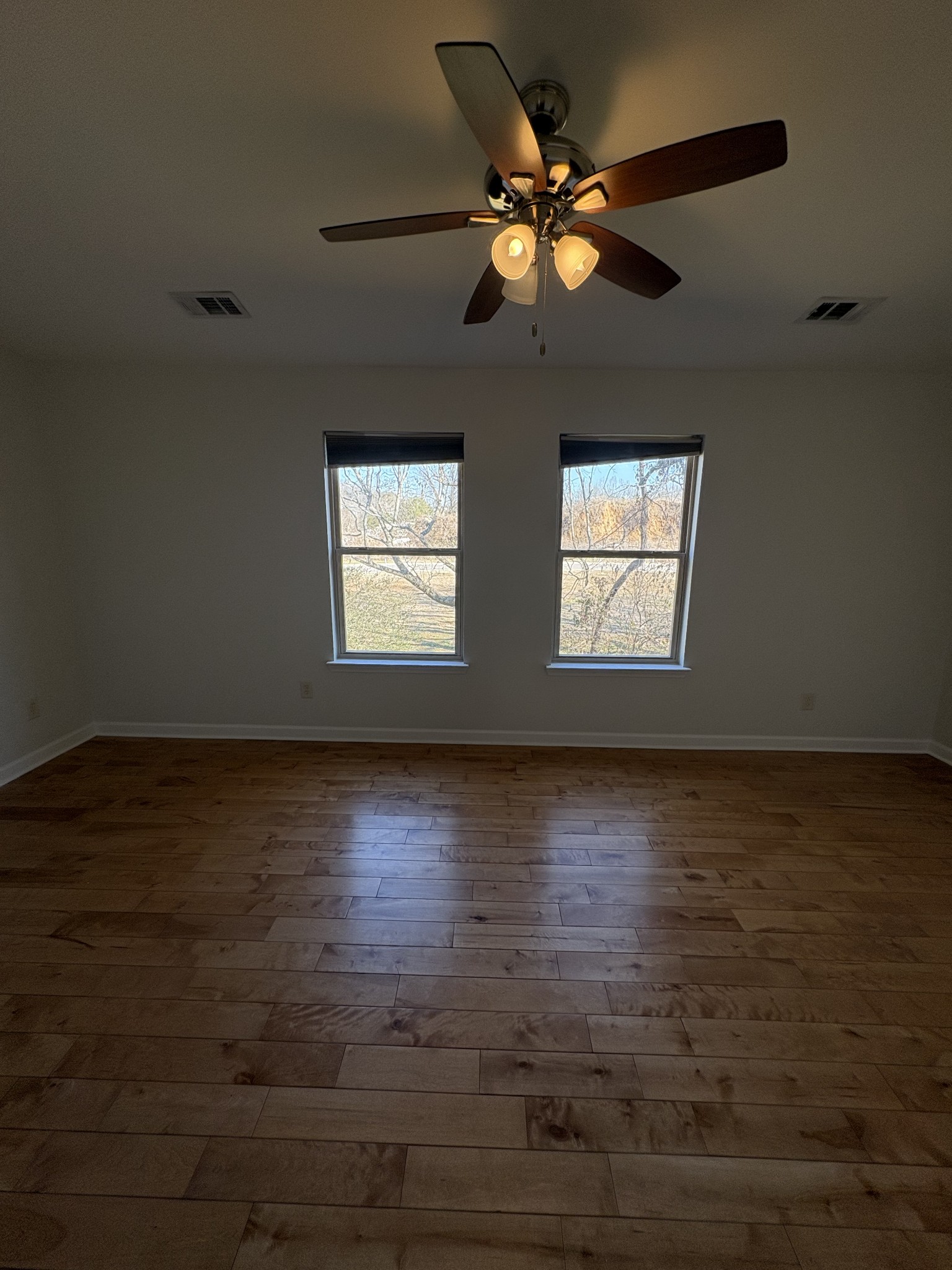 735 Tulip Grove Road, Unit 303 Hermitage, TN 37076 - Photo 13 of 16 an empty room with wooden floor and windows