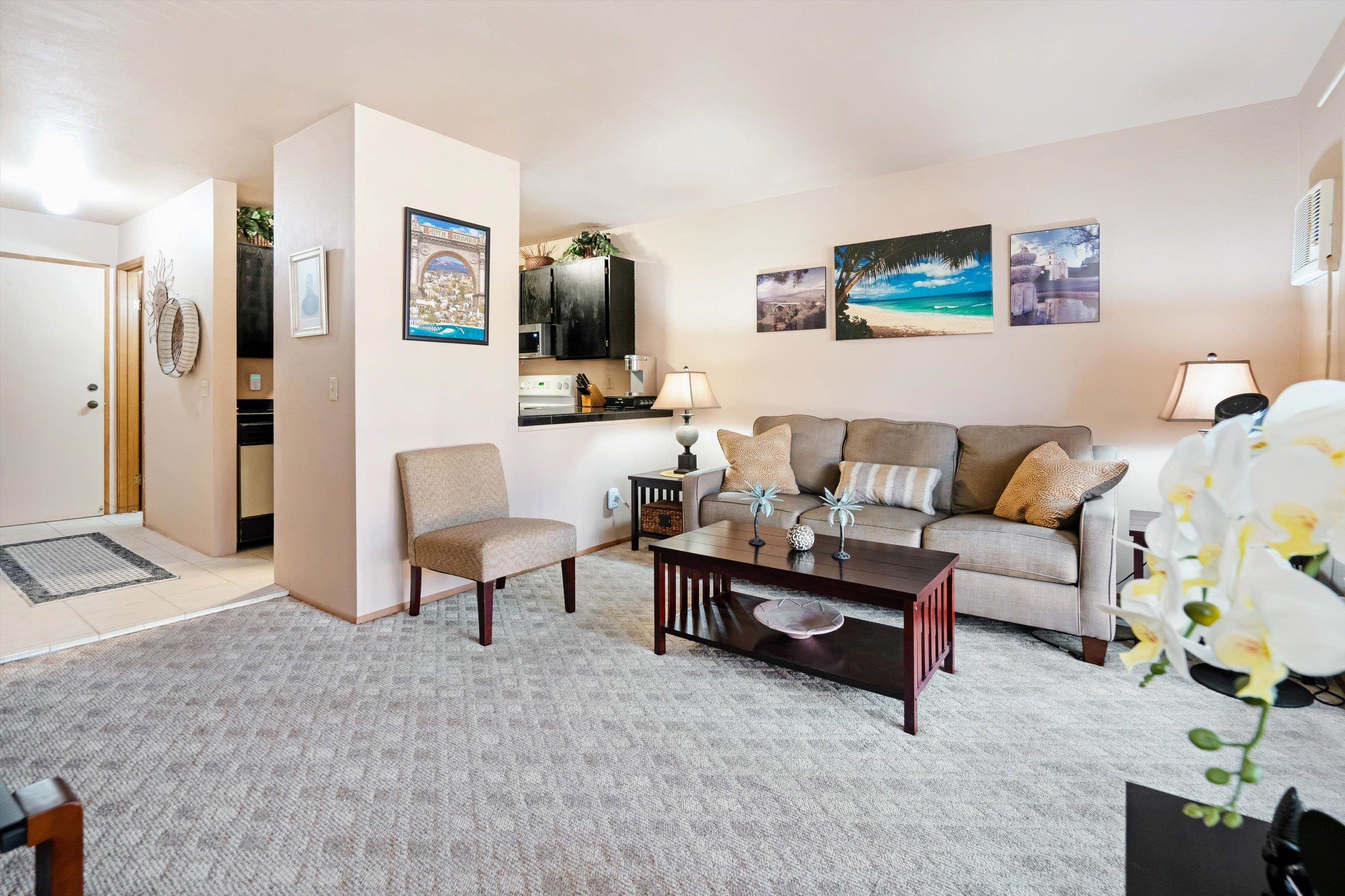 3740 Lower Honoapiilani Road, Unit C102 Lahaina, HI 96761 - Photo 1 of 50 a living room with furniture and a flat screen tv