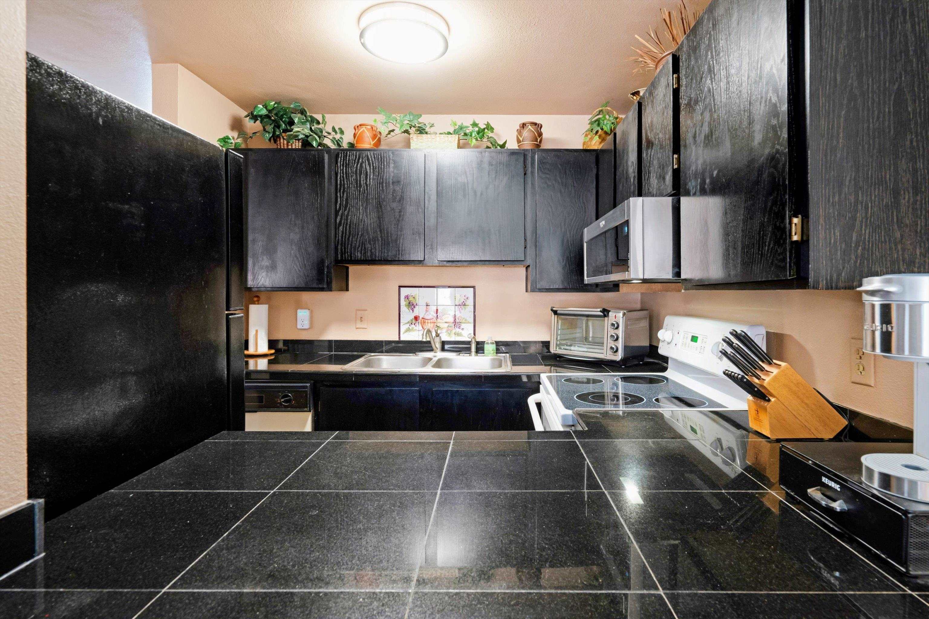 3740 Lower Honoapiilani Road, Unit C102 Lahaina, HI 96761 - Photo 13 of 50 a kitchen with a sink and cabinets