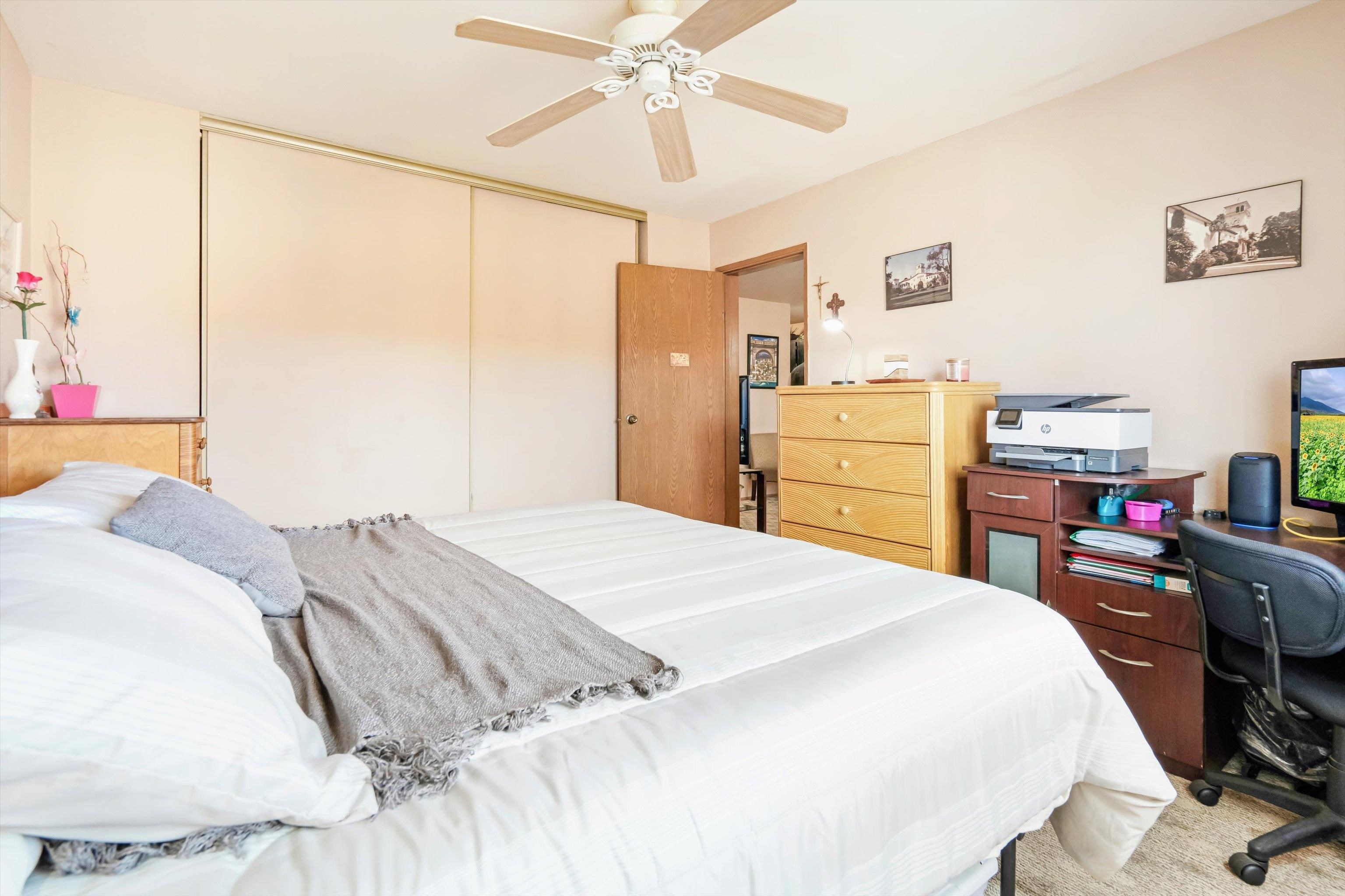 3740 Lower Honoapiilani Road, Unit C102 Lahaina, HI 96761 - Photo 16 of 50 a bedroom with a bed and a chandelier